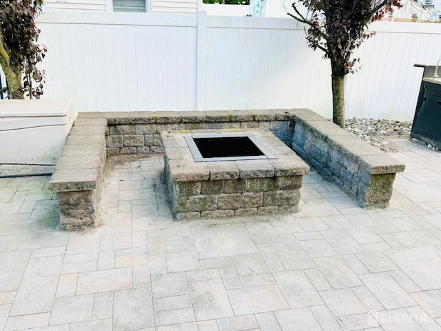 exterior view of a fire pit and fence