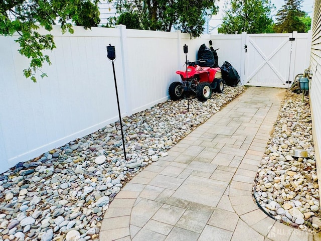 view of patio with a gate and fence