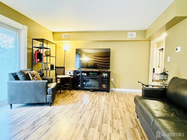 living area with wood finished floors and baseboards