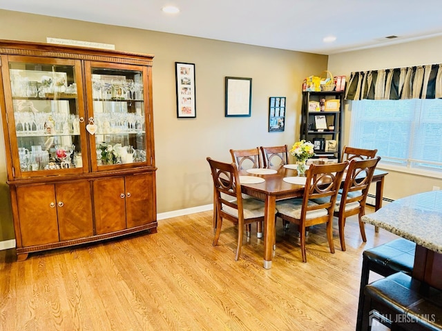 dining area with light wood-style floors, recessed lighting, and baseboards