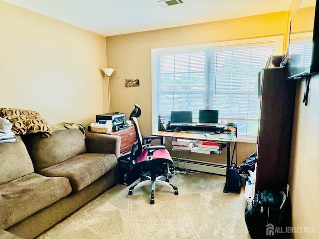office with a baseboard radiator, healthy amount of natural light, and carpet floors