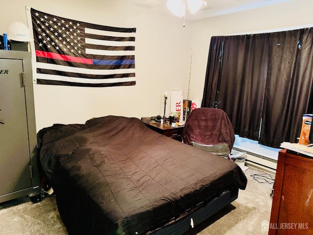 bedroom with a baseboard radiator and carpet floors