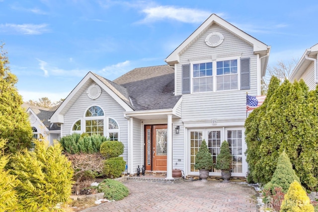 traditional-style home with roof with shingles