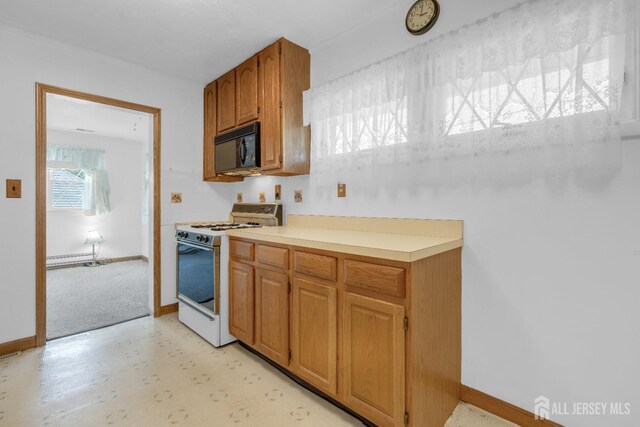 49 Charles Ter, Piscataway, NJ 08854 - kitchen featuring white gas range, black microwave, light countertops, brown cabinetry, and light flooring