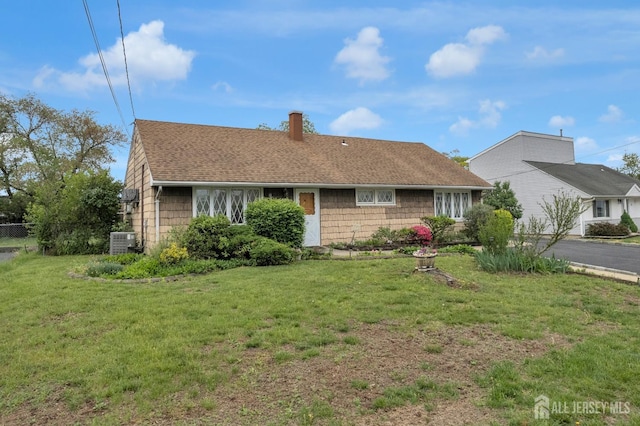 49 Charles Ter, Piscataway, NJ 08854 - view of front of home with a chimney and roof with shingles