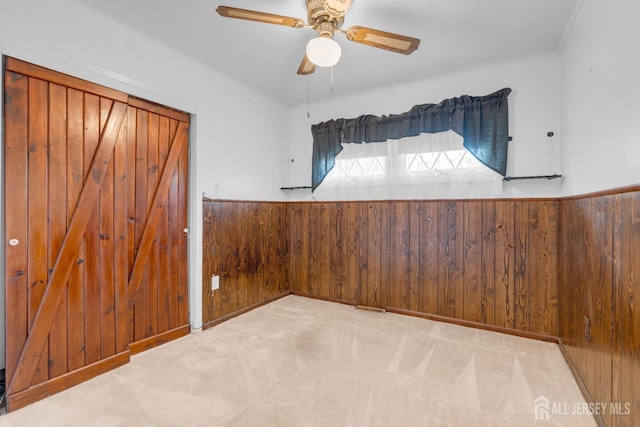 49 Charles Ter, Piscataway, NJ 08854 - carpeted empty room with wooden walls, wainscoting, a ceiling fan, and ornamental molding
