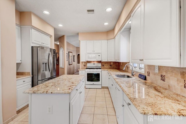 35 Brighton Ct, Monroe, NJ 08831 - kitchen with white appliances, a sink, a center island, light tile patterned floors, and backsplash