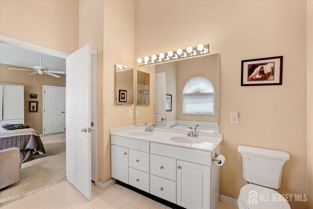 35 Brighton Ct, Monroe, NJ 08831 - bathroom with double vanity, a ceiling fan, toilet, baseboards, and a high ceiling