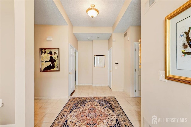 35 Brighton Ct, Monroe, NJ 08831 - corridor featuring light tile patterned floors, a textured ceiling, and baseboards