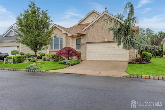 35 Brighton Ct, Monroe, NJ 08831 - view of front of home with concrete driveway, a front lawn, brick siding, and an attached garage