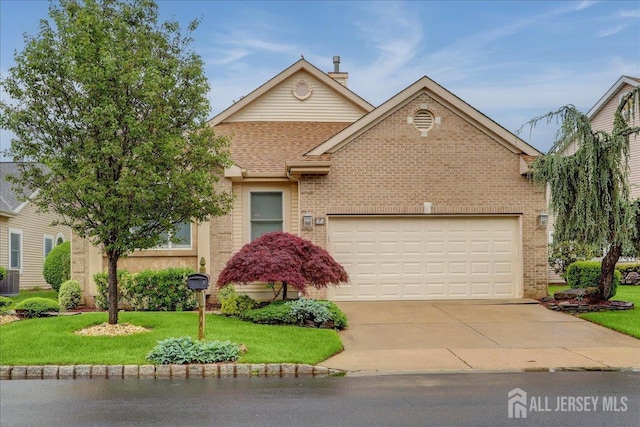35 Brighton Ct, Monroe, NJ 08831 - view of front of house featuring brick siding, concrete driveway, a front yard, an attached garage, and roof with shingles