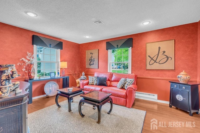 539 Old Nassau Rd Unit B, Monroe, NJ 08831 - living area featuring wood finished floors, a baseboard radiator, a textured ceiling, baseboards, and recessed lighting
