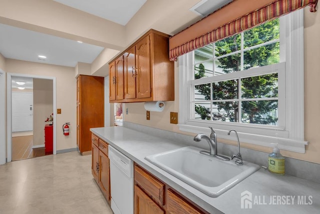 539 Old Nassau Rd Unit B, Monroe, NJ 08831 - kitchen with white dishwasher, a sink, brown cabinetry, and light countertops