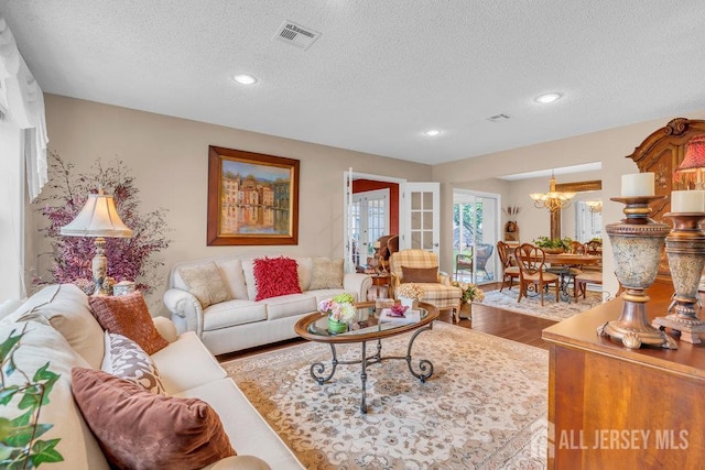 539 Old Nassau Rd Unit B, Monroe, NJ 08831 - living area featuring a textured ceiling, wood finished floors, a chandelier, and recessed lighting