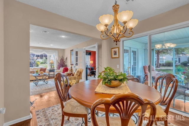 539 Old Nassau Rd Unit B, Monroe, NJ 08831 - dining space with a chandelier, a textured ceiling, light wood finished floors, healthy amount of natural light, and french doors