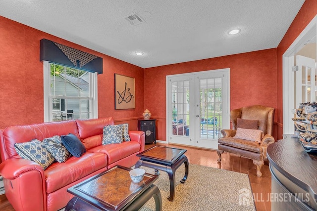 539 Old Nassau Rd Unit B, Monroe, NJ 08831 - living area with french doors, wood-type flooring, a textured ceiling, plenty of natural light, and recessed lighting