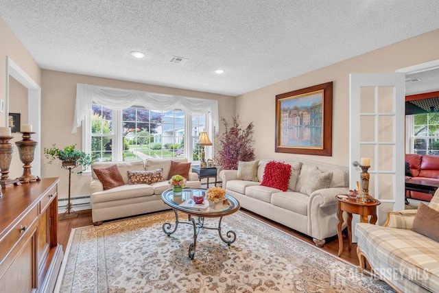 539 Old Nassau Rd Unit B, Monroe, NJ 08831 - living room with a baseboard heating unit, a textured ceiling, wood finished floors, and recessed lighting