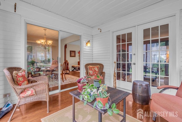 539 Old Nassau Rd Unit B, Monroe, NJ 08831 - living area with wood finished floors, a chandelier, wooden walls, and french doors