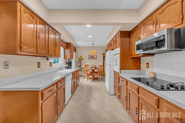 539 Old Nassau Rd Unit B, Monroe, NJ 08831 - kitchen featuring white appliances, light countertops, brown cabinetry, a sink, and recessed lighting
