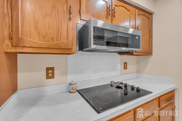 539 Old Nassau Rd Unit B, Monroe, NJ 08831 - kitchen featuring stainless steel microwave, black electric cooktop, light countertops, and backsplash