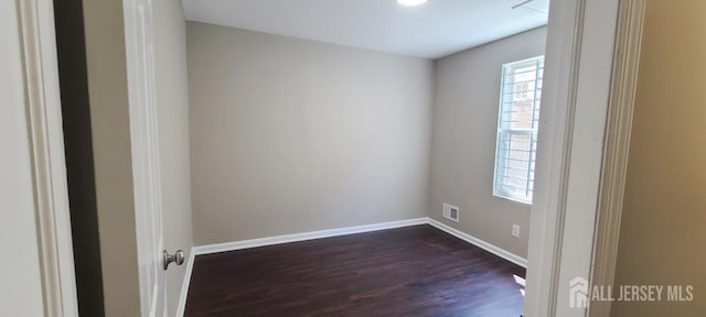 110 Jefferson St, Perth Amboy, NJ 08861 - spare room featuring dark wood-style floors and baseboards