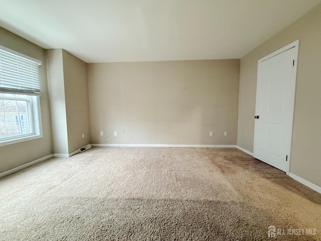 spare room with carpet floors and baseboards