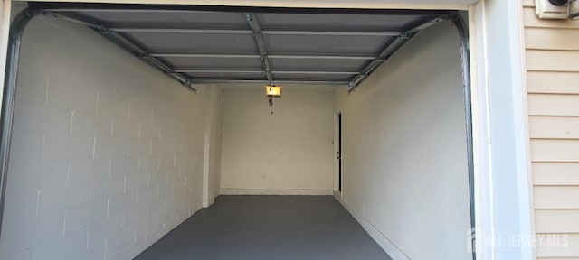 110 Jefferson St, Perth Amboy, NJ 08861 - garage featuring concrete block wall and a garage door opener