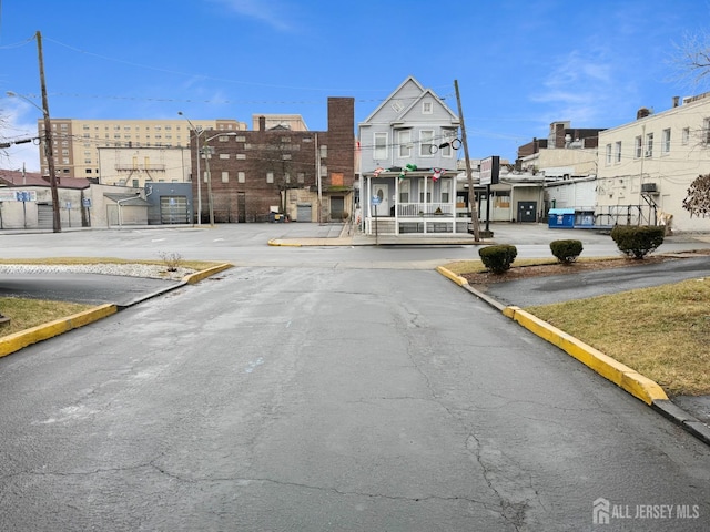 110 Jefferson St, Perth Amboy, NJ 08861 - view of asphalt road featuring curbs and street lighting