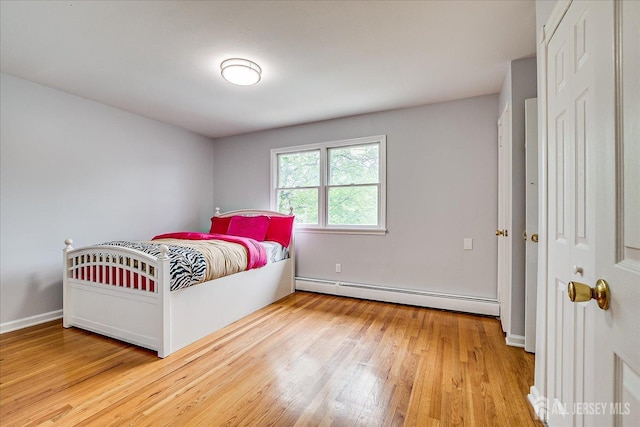 878 Beatrice Pkwy, Edison, NJ 08820 - bedroom featuring baseboard heating, light wood-style floors, and baseboards