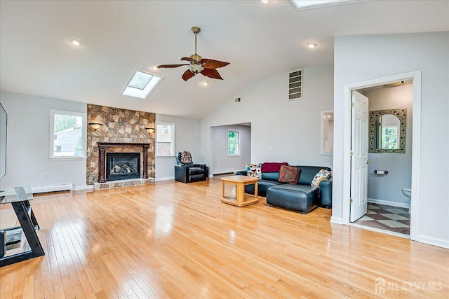 878 Beatrice Pkwy, Edison, NJ 08820 - living area with ceiling fan, light wood-style floors, healthy amount of natural light, baseboard heating, and lofted ceiling