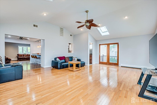 878 Beatrice Pkwy, Edison, NJ 08820 - living room with a ceiling fan, light wood-type flooring, a skylight, high vaulted ceiling, and baseboards