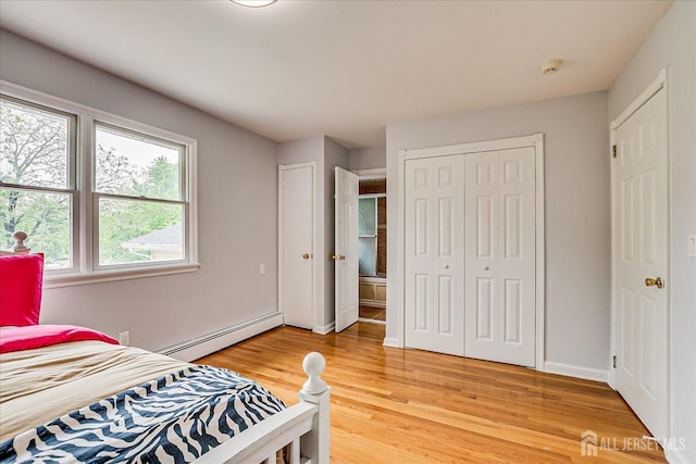 878 Beatrice Pkwy, Edison, NJ 08820 - bedroom with multiple windows, baseboard heating, light wood-style flooring, and baseboards