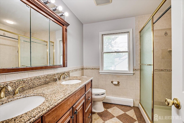 878 Beatrice Pkwy, Edison, NJ 08820 - bathroom featuring a baseboard heating unit, tile walls, toilet, double vanity, and a shower stall
