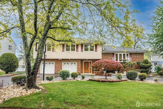 878 Beatrice Pkwy, Edison, NJ 08820 - split level home featuring a garage, driveway, a front yard, and brick siding