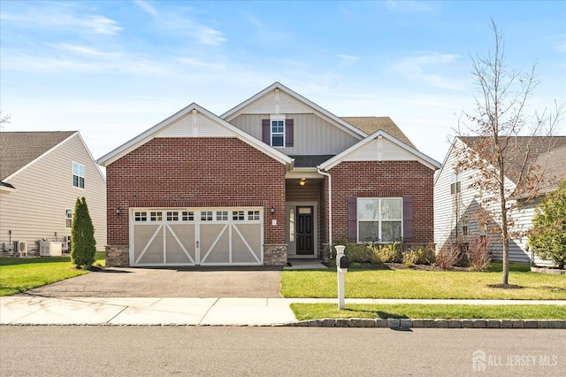 5 Anthem St, Monroe, NJ 08831 - view of front of home featuring asphalt driveway, a front yard, brick siding, board and batten siding, and an attached garage
