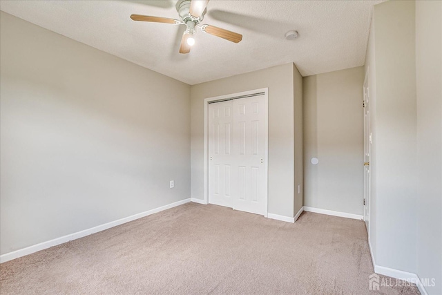 922 Thomas Ave, North Brunswick, NJ 08902 - unfurnished bedroom with light carpet, baseboards, a closet, a ceiling fan, and a textured ceiling