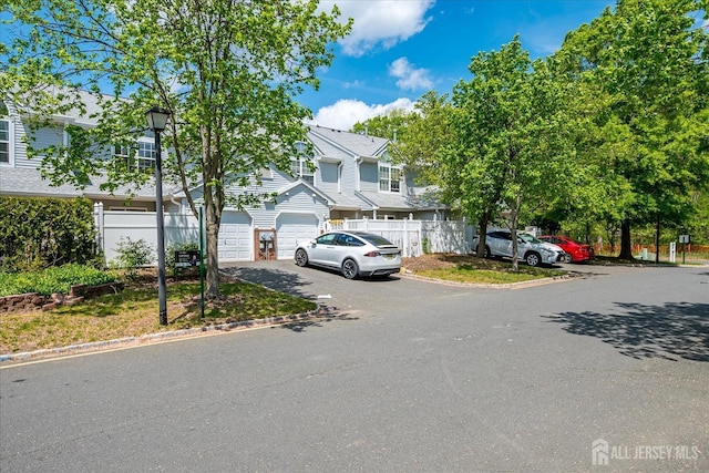 922 Thomas Ave, North Brunswick, NJ 08902 - view of property featuring driveway, fence, and a garage
