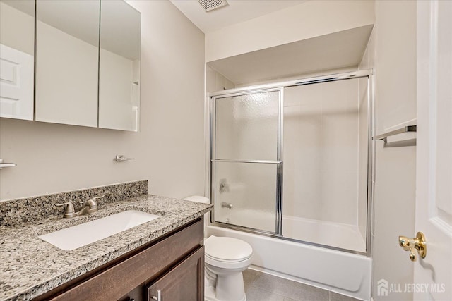 922 Thomas Ave, North Brunswick, NJ 08902 - bathroom with toilet, bath / shower combo with glass door, vanity, and tile patterned flooring