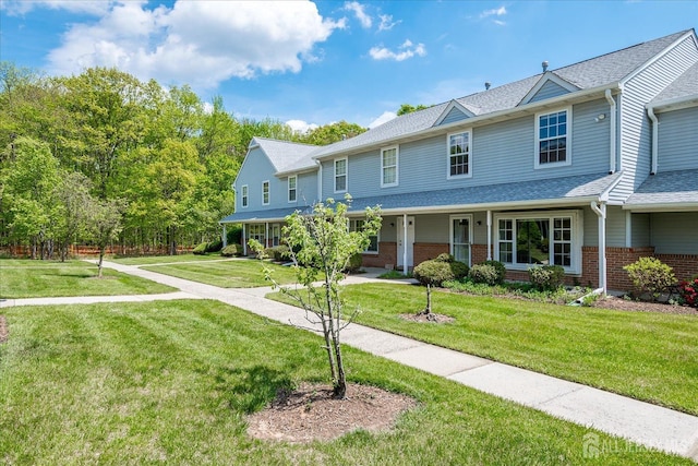 922 Thomas Ave, North Brunswick, NJ 08902 - townhome / multi-family property featuring brick siding, a front yard, a shingled roof, and a porch