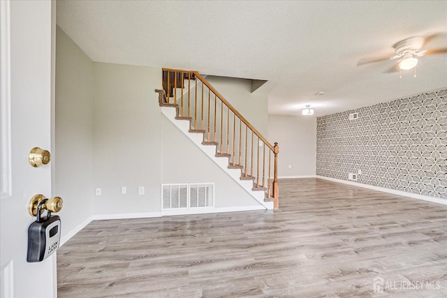 922 Thomas Ave, North Brunswick, NJ 08902 - entrance foyer featuring stairway, ceiling fan, wood finished floors, a textured ceiling, and baseboards