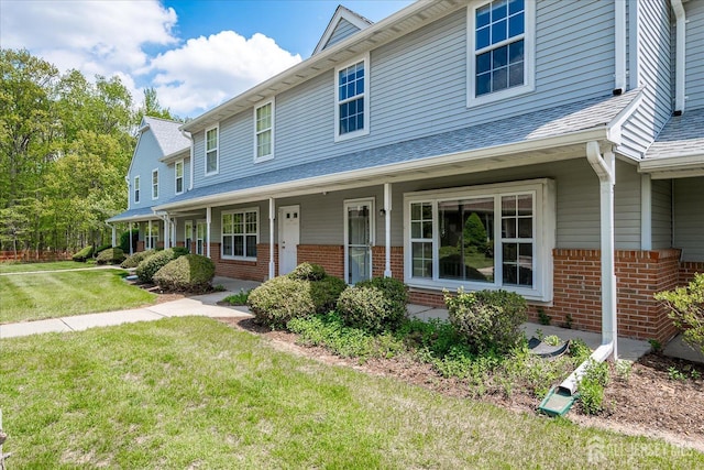 922 Thomas Ave, North Brunswick, NJ 08902 - view of front facade featuring brick siding, a front yard, and a porch