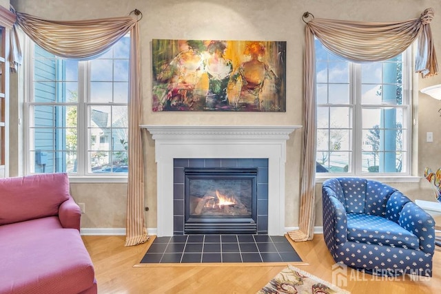 sitting room featuring hardwood / wood-style flooring and a tile fireplace