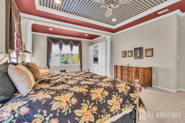 carpeted bedroom featuring ornamental molding, a raised ceiling, and decorative columns