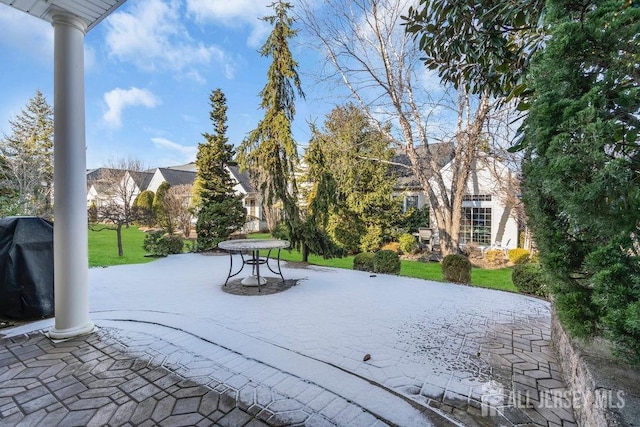 view of property's community with a yard and a patio area