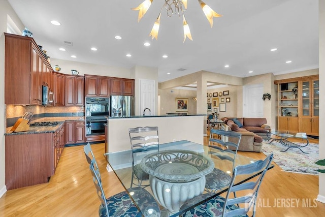 dining space featuring sink and light hardwood / wood-style flooring