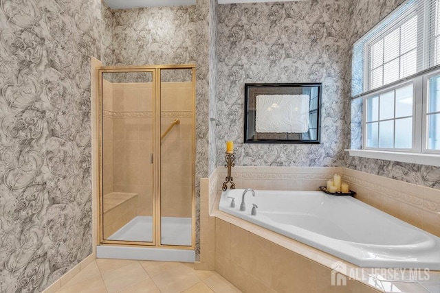 bathroom featuring tile patterned floors and shower with separate bathtub