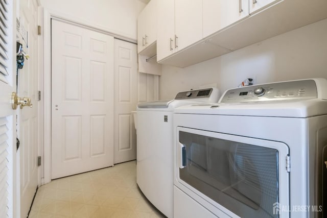 laundry room with cabinets and separate washer and dryer