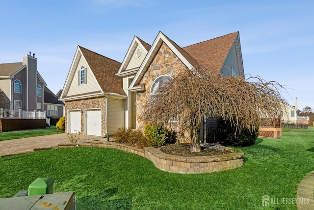 view of front of property with a garage and a front yard