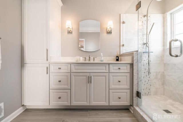 bathroom with an enclosed shower, vanity, and hardwood / wood-style floors