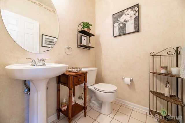 bathroom with tile patterned flooring and toilet